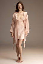 Woman wearing a powder pink satin robe over a lace-trim slip nightgown — Belle Bonjour BM-1915