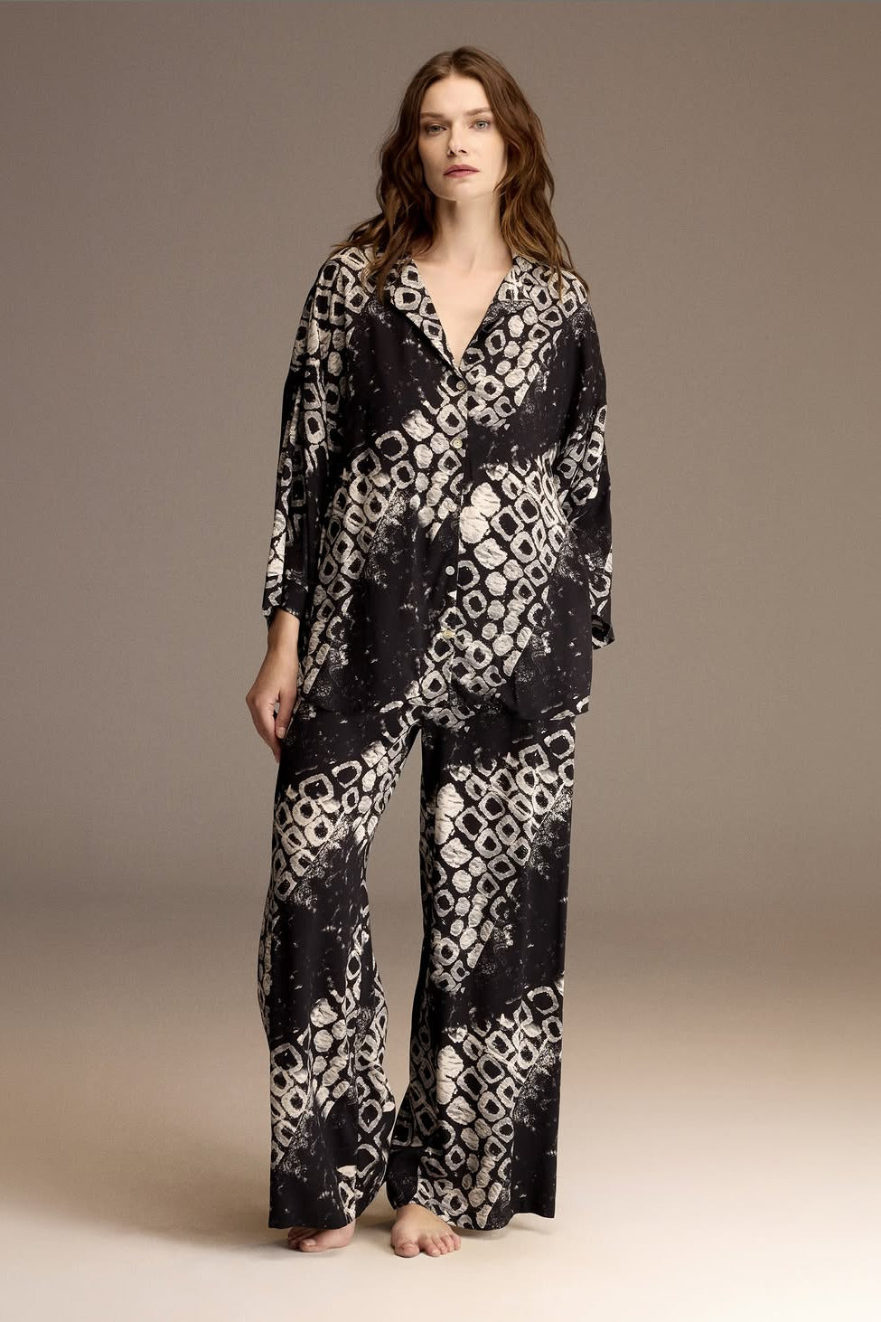 Woman wearing a black and ivory printed viscose shirt and wide-leg trousers — Belle Bonjour BM-1966