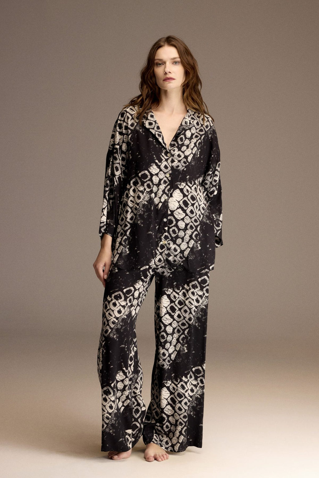 Woman wearing a black and ivory printed viscose shirt and wide-leg trousers — Belle Bonjour BM-1966
