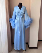 Light blue feather bridal robe by window